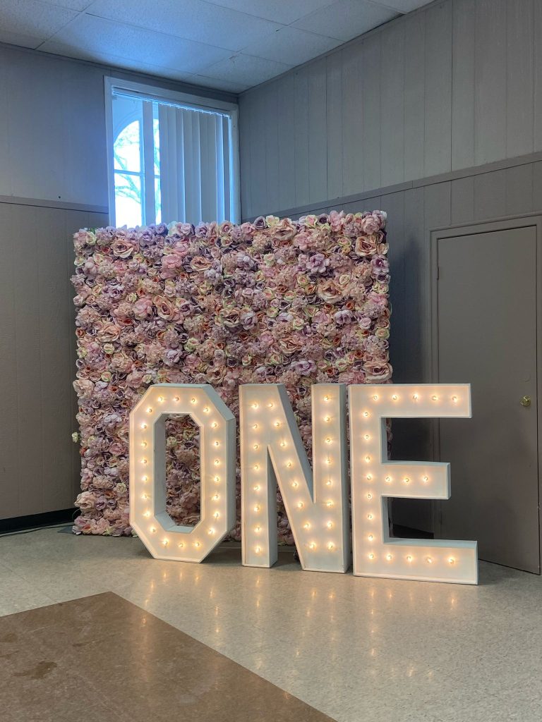 Rent Oshawa marquee letters in front of a floral wall