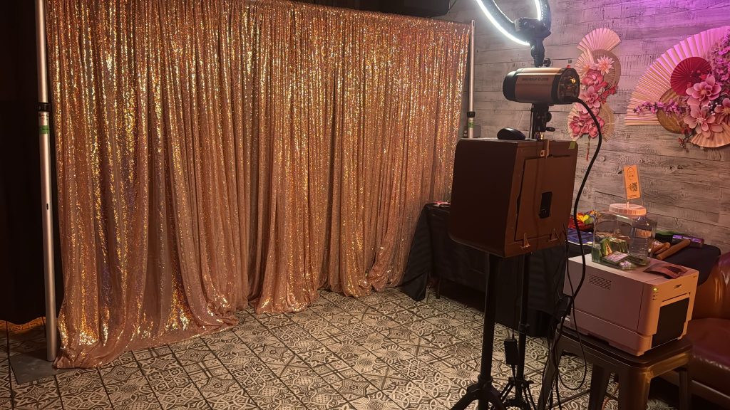 A RIchmond Hill pod photo booth with a backdrop and props.
