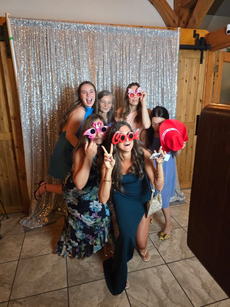 A Hamilton photo booth photo where the subjects are wearing props