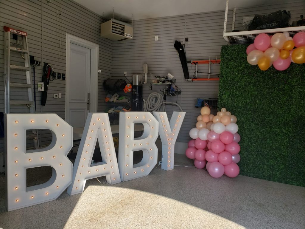 Large light up letters in pickering with a green boxwood backdrop and balloons